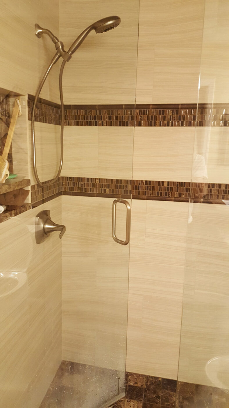 Shower with Mosaic Accent Band by Masterpiece Tile and Grout in the DFW area